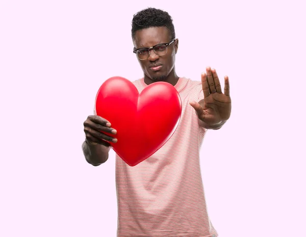 Young African American Man Holding Red Heart Open Hand Doing — Stock Photo, Image