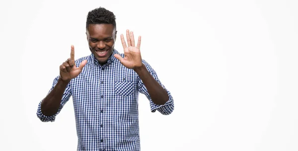 指で上向きの表示と青のシャツを着ている若いアフリカ系アメリカ人の数は自信を持って 幸せな笑みを浮かべている間 — ストック写真