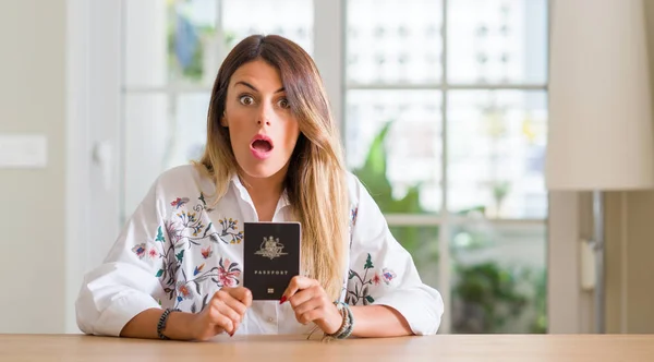 Young Woman Home Holding Passport Australia Scared Shock Surprise Face — Stock Photo, Image