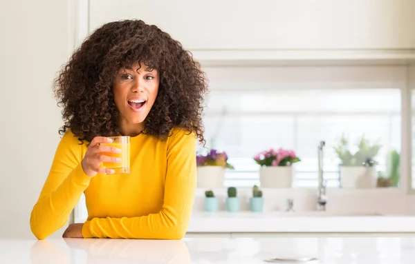 Afroamerikanerin Trinkt Orangensaft Einem Glas Erschrocken Mit Einem Überraschten Gesicht — Stockfoto