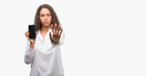 Young Hispanic Woman Using Smartphone Open Hand Doing Stop Sign — Stock Photo, Image