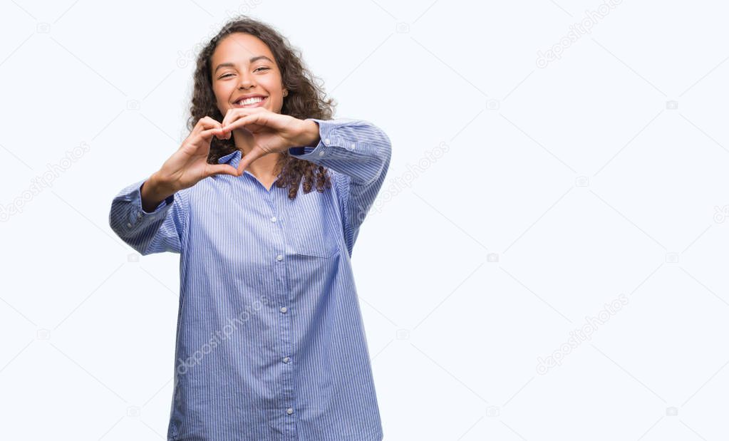 Young hispanic business woman smiling in love showing heart symbol and shape with hands. Romantic concept.