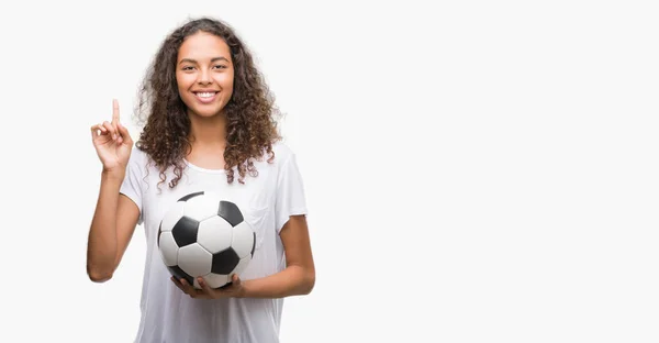 Young Hispanic Woman Holding Soccer Football Ball Surprised Idea Question — Stock Photo, Image