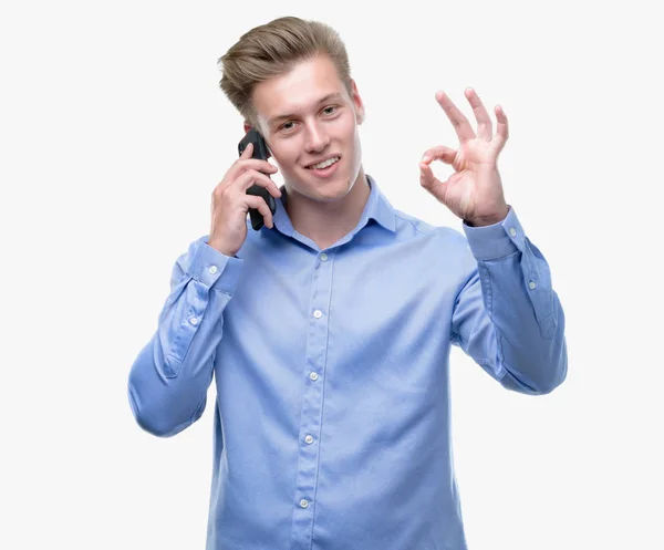 Ung Snygg Blond Man Med Smartphone Gör Tecken Med Fingrarna — Stockfoto