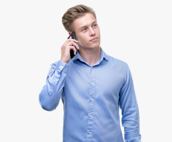 Young Handsome Blond Man Using Smartphone Serious Face Thinking Question — Stock Photo, Image