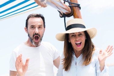 Orta yaş çift Yelkenli bir sürpriz yüz, korkuyor ve heyecanlı korku ifadesi ile şok korkmuş üzerinde seyahat