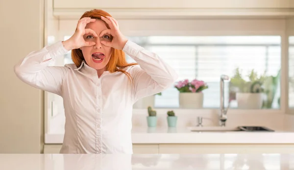 Redhead Woman Kitchen Doing Gesture Binoculars Sticking Tongue Out Eyes — Stock Photo, Image