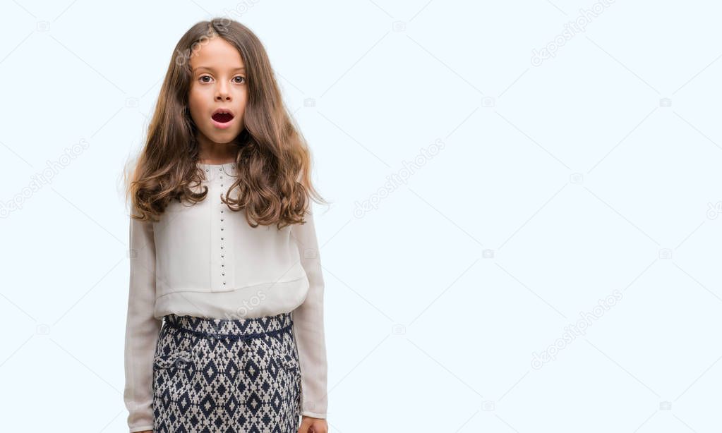 Brunette hispanic girl afraid and shocked with surprise expression, fear and excited face.