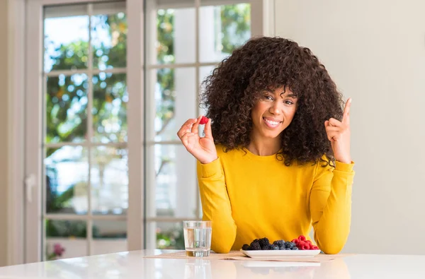 Afro Americana Comendo Framboesas Mirtilos Casa Surpreso Com Uma Ideia — Fotografia de Stock