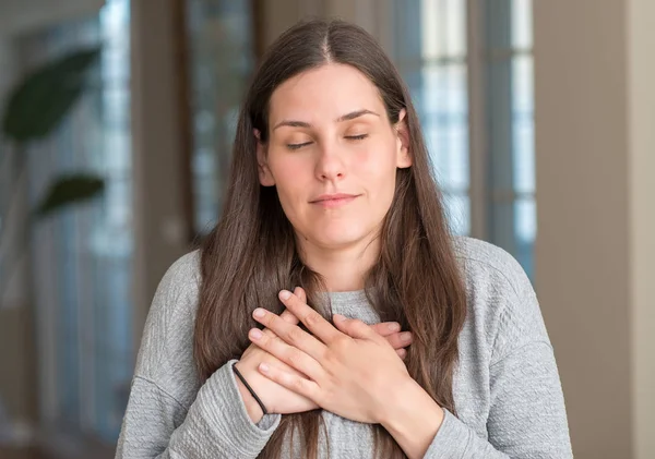 Young Beautiful Woman Home Smiling Hands Chest Closed Eyes Grateful — Stock Photo, Image