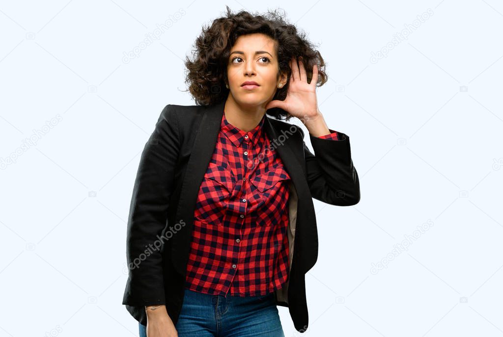 Beautiful arab woman holding hand near ear trying to listen to interesting news expressing communication concept and gossip