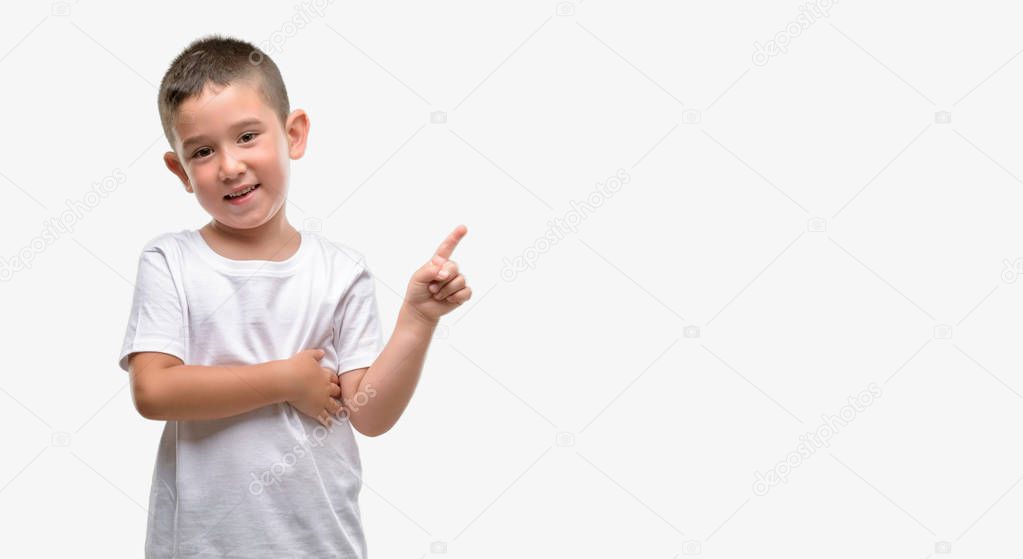 Dark haired little child very happy pointing with hand and finger to the side