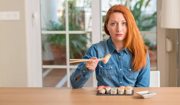 Redhead Woman Eating Sushi Using Chopsticks Confident Expression Smart Face — Stock Photo, Image