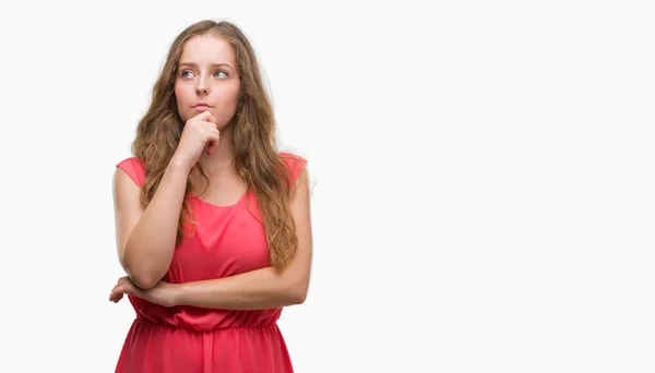 Young Blonde Woman Wearing Pink Dress Serious Face Thinking Question Royalty Free Stock Images