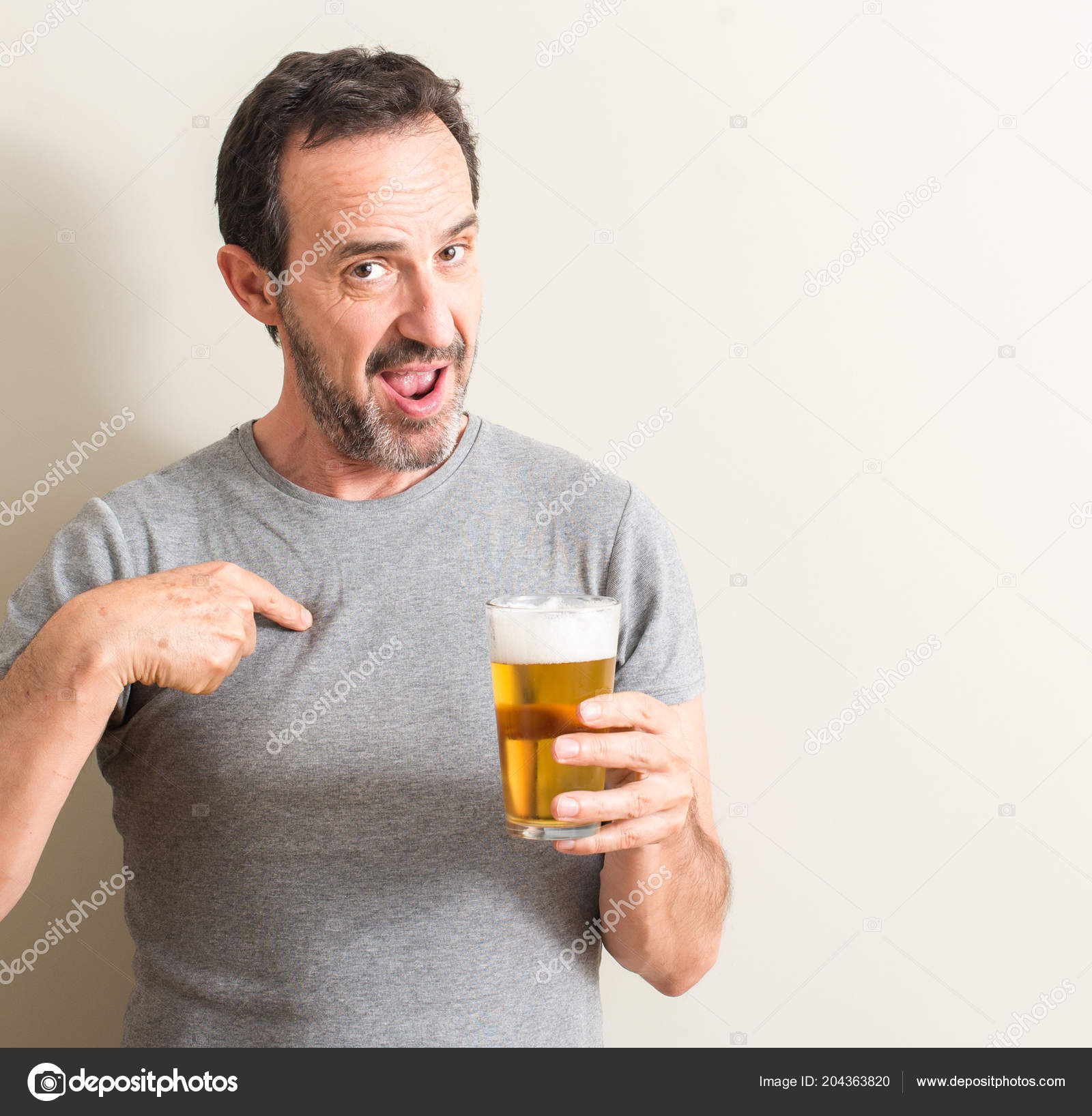 rekenkundig Uitgebreid fluiten Senior Man Drinking Beer Surprise Face Pointing Finger Himself Stock Photo  by ©Krakenimages.com 204363820
