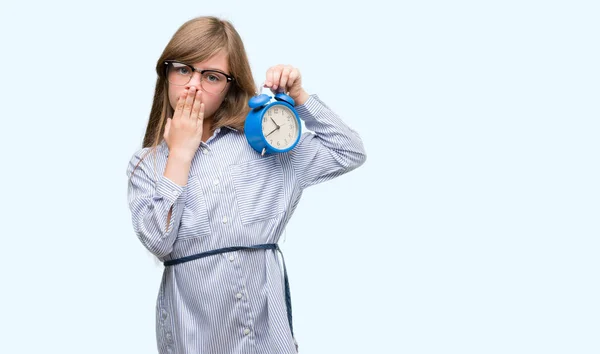 Young Blonde Child Holding Alarm Clock Cover Mouth Hand Shocked — Stock Photo, Image