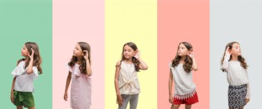 Kolaj esmer İspanyol kız bir işitme söylenti ya da dedikodu için dinleme kulak üzerinde el ile gülümseyen farklı kıyafetler giyiyor. Sağırlık kavramı.