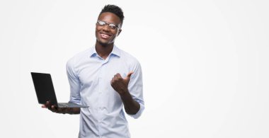 El ve parmak ile yukarı dönük mutlu yüz gülümseyen ile bilgisayar dizüstü kullanarak genç Afro-Amerikalı iş adamı