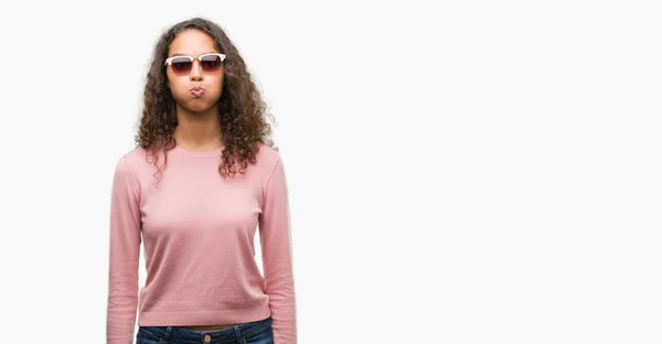 Beautiful Young Hispanic Woman Wearing Sunglasses Puffing Cheeks Funny Face — Stock Photo, Image