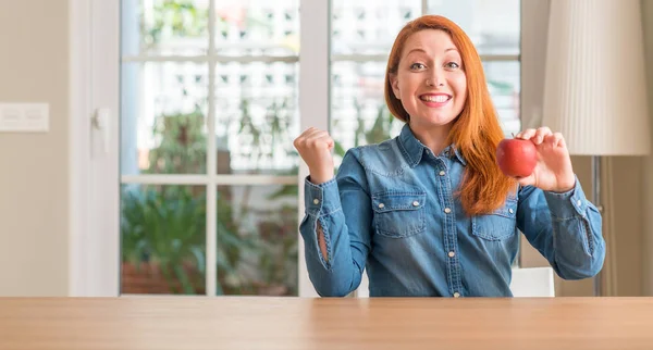 Redhead Woman Holding Red Apple Home Screaming Proud Celebrating Victory — Stock Photo, Image