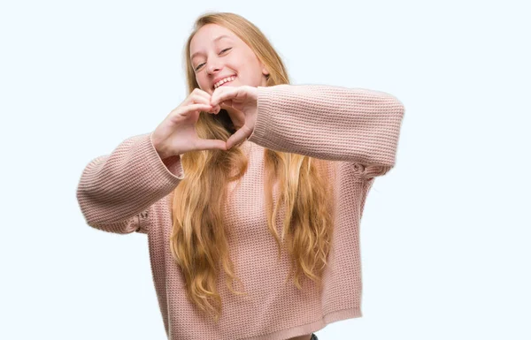 Blonde Teenager Woman Wearing Pink Sweater Smiling Love Showing Heart — Stock Photo, Image