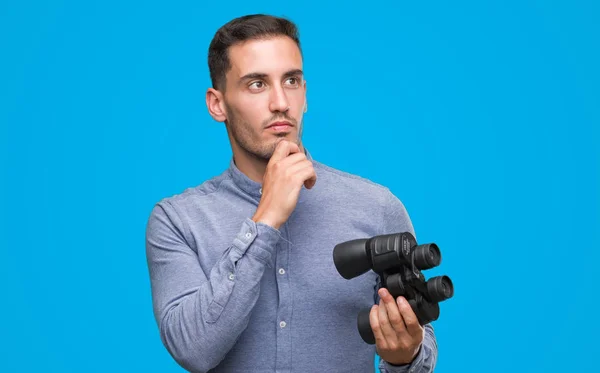 Handsome Young Man Looking Binoculars Serious Face Thinking Question Very — Stock Photo, Image