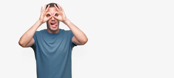 Handsome Young Casual Man Doing Gesture Binoculars Sticking Tongue Out — Stock Photo, Image