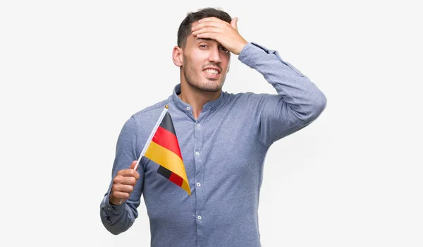 Joven Guapo Sosteniendo Una Bandera Alemania Acentuado Con Mano Cabeza — Foto de Stock