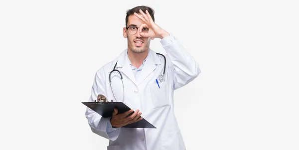 Bonito Jovem Médico Homem Segurando Uma Prancheta Com Rosto Feliz — Fotografia de Stock