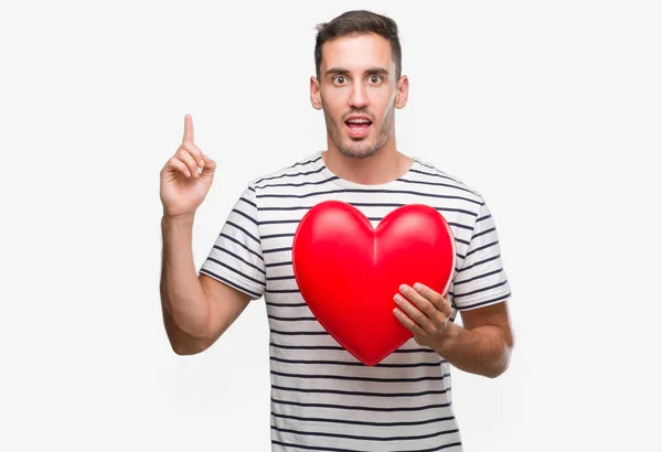 Handsome Young Man Love Holding Red Heart Surprised Idea Question — Stock Photo, Image