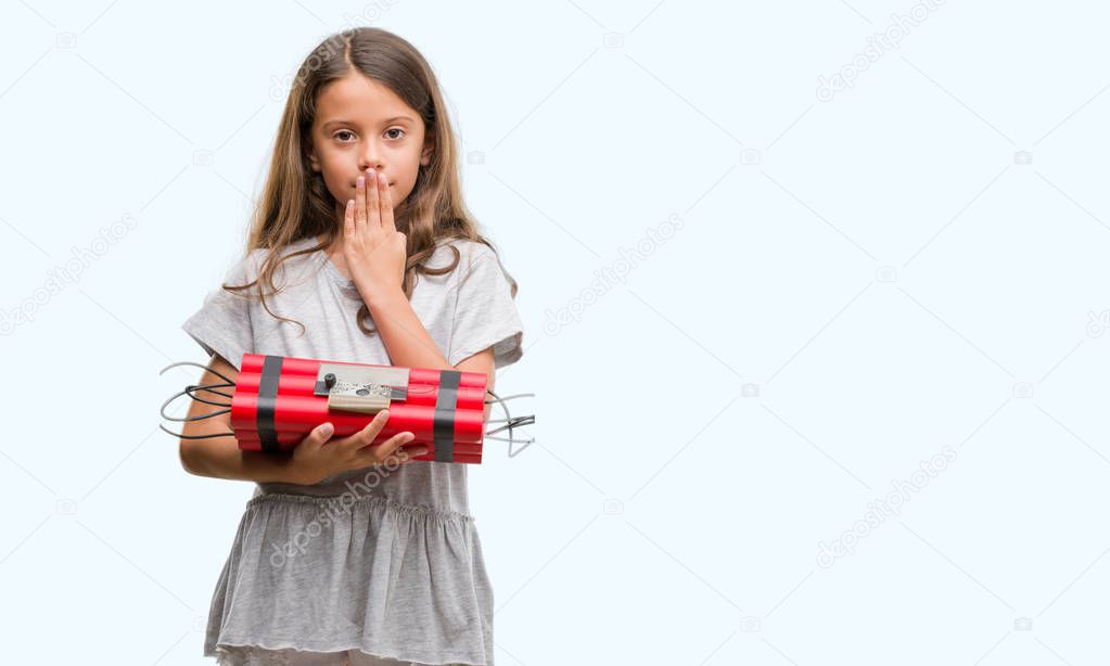 Brunette hispanic girl holding a bomb cover mouth with hand shocked with shame for mistake, expression of fear, scared in silence, secret concept