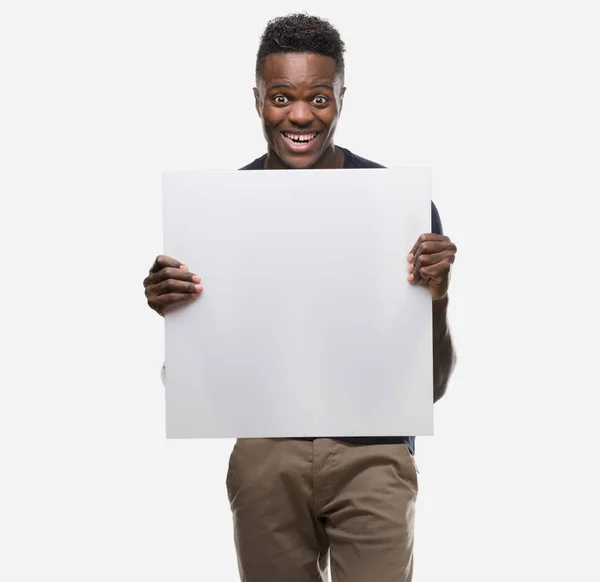 Young African American Man Holding Banner Screaming Proud Celebrating Victory — Stock Photo, Image