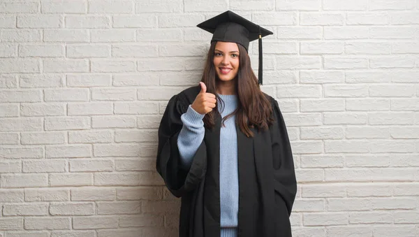 Young Brunette Woman Standing White Brick Wall Wearing Graduate Uniform — Stock Photo, Image