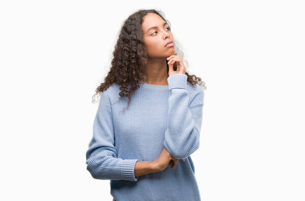 Beautiful young hispanic woman serious face thinking about question, very confused idea