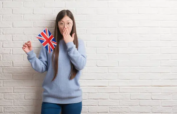 Jovem Chinesa Sobre Parede Tijolo Segurando Bandeira Inglaterra Cobrir Boca — Fotografia de Stock