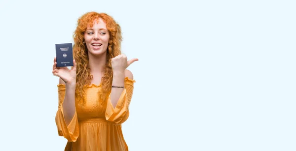 Young Redhead Woman Holding Passport Germany Pointing Showing Thumb Side — Stock Photo, Image