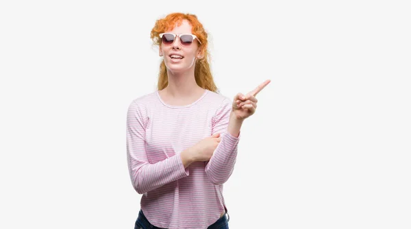 Young Redhead Woman Wearing Sunglasses Very Happy Pointing Hand Finger — Stock Photo, Image