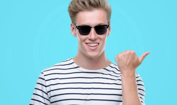 Young Handsome Blond Man Wearing Sunglasess Pointing Hand Finger Happy — Stock Photo, Image