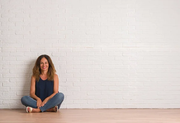 Middle Age Hispanic Woman Sitting Floor White Brick Wall Happy — Stock Photo, Image