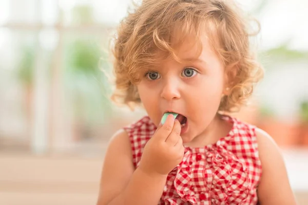 Beautiful Blonde Child Blue Eyes Eating Candy Home — Stock Photo, Image