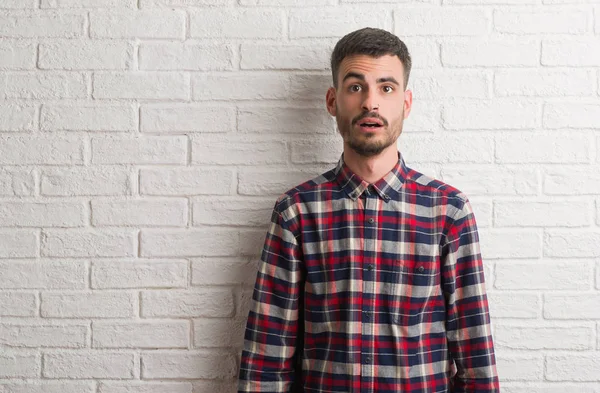 Joven Hombre Adulto Pie Sobre Pared Ladrillo Blanco Asustado Sorprendido — Foto de Stock