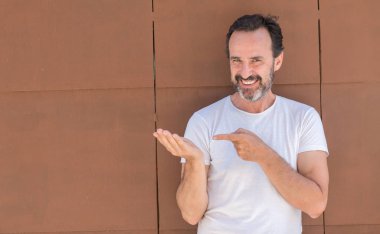 Üst düzey yakışıklı duvar el ve parmak ile işaret çok mutlu üzerinde duran