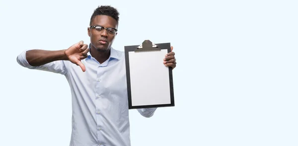 Young African American Man Holding Clipboarad Angry Face Negative Sign — Stock Photo, Image