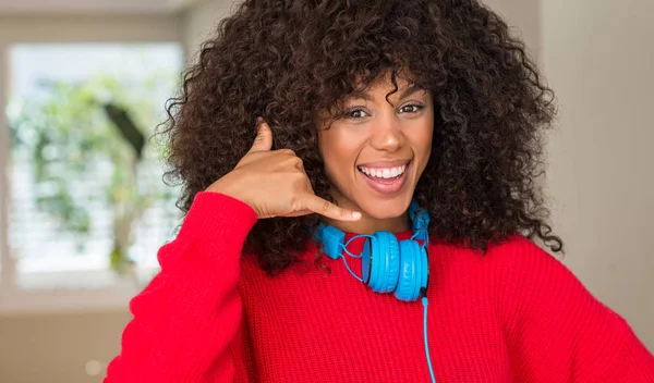 African American Woman Wearing Headphones Smiling Doing Phone Gesture Hand — Stock Photo, Image