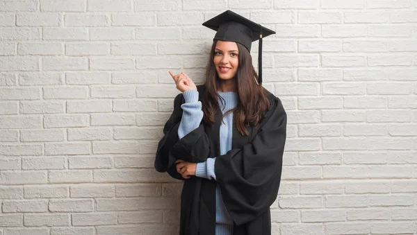 Young Brunette Woman Standing White Brick Wall Wearing Graduate Uniform — Stock Photo, Image
