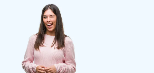 Young beautiful hispanic woman wearing a sweater winking looking at the camera with sexy expression, cheerful and happy face. — Stock Image Young Beautiful Hispanic Woman Wearing Sweater Winking Looking Camera Sexy Stock Picture