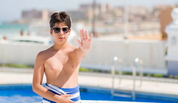 ビーチでプールで休日に若い子が防衛ジェスチャー 深刻な自信を持って式に一時停止の標識をやって手を開いてください — ストック写真