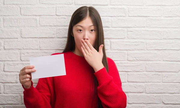 Young Chinese Woman Brick Wall Holding Blank Paper Cover Mouth — Stock Photo, Image