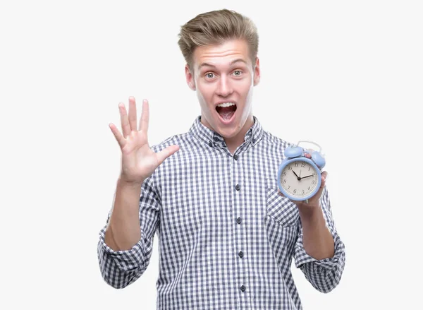 Young Handsome Blond Man Holding Alarm Clock Very Happy Excited — Stock Photo, Image