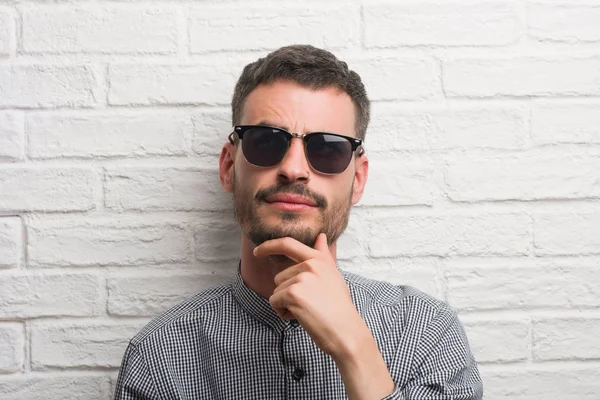 Young Adult Man Wearing Sunglasses Standing White Brick Wall Serious — Stock Photo, Image